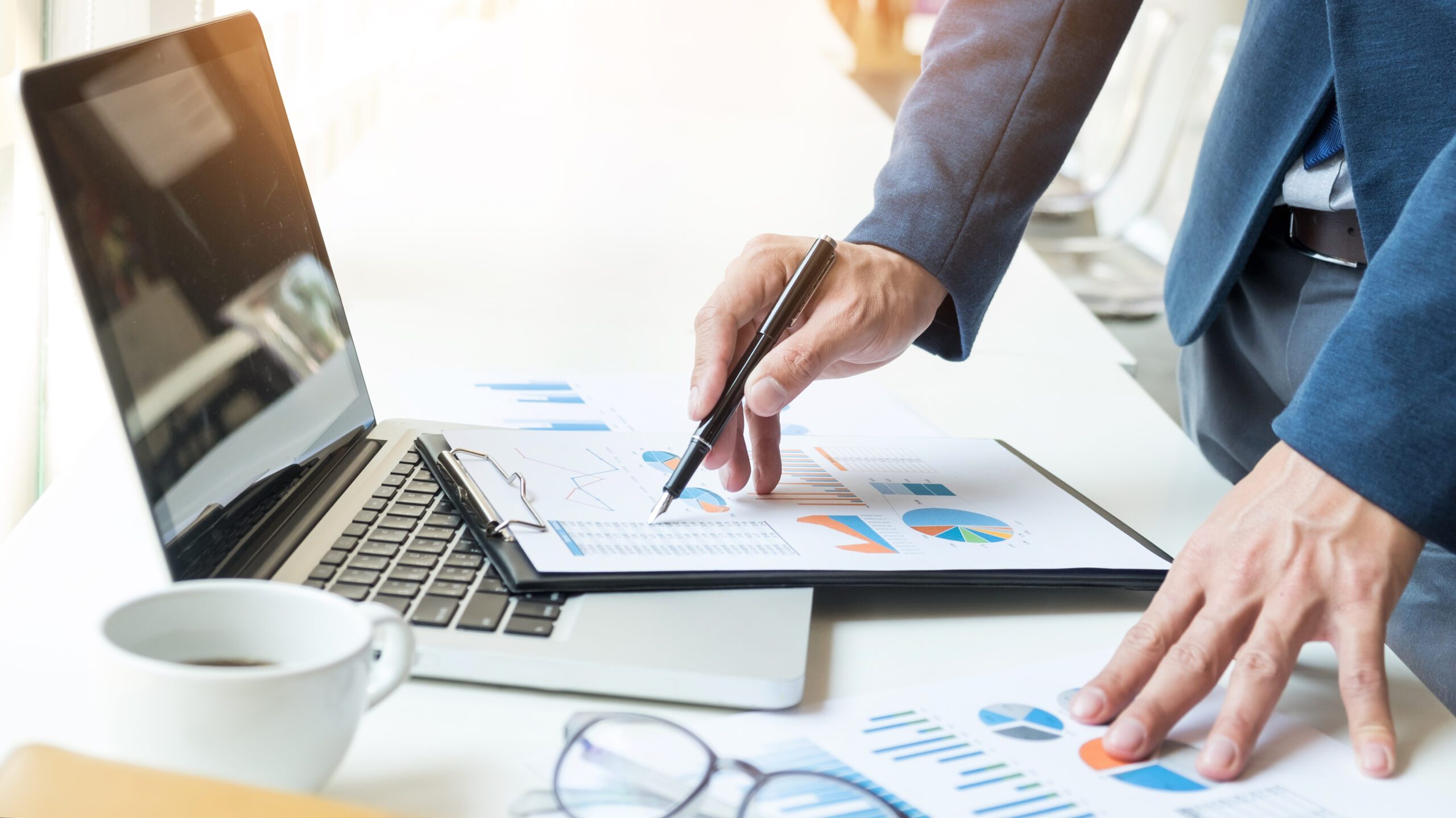 Businessman Working at Office with Graph Data Documents